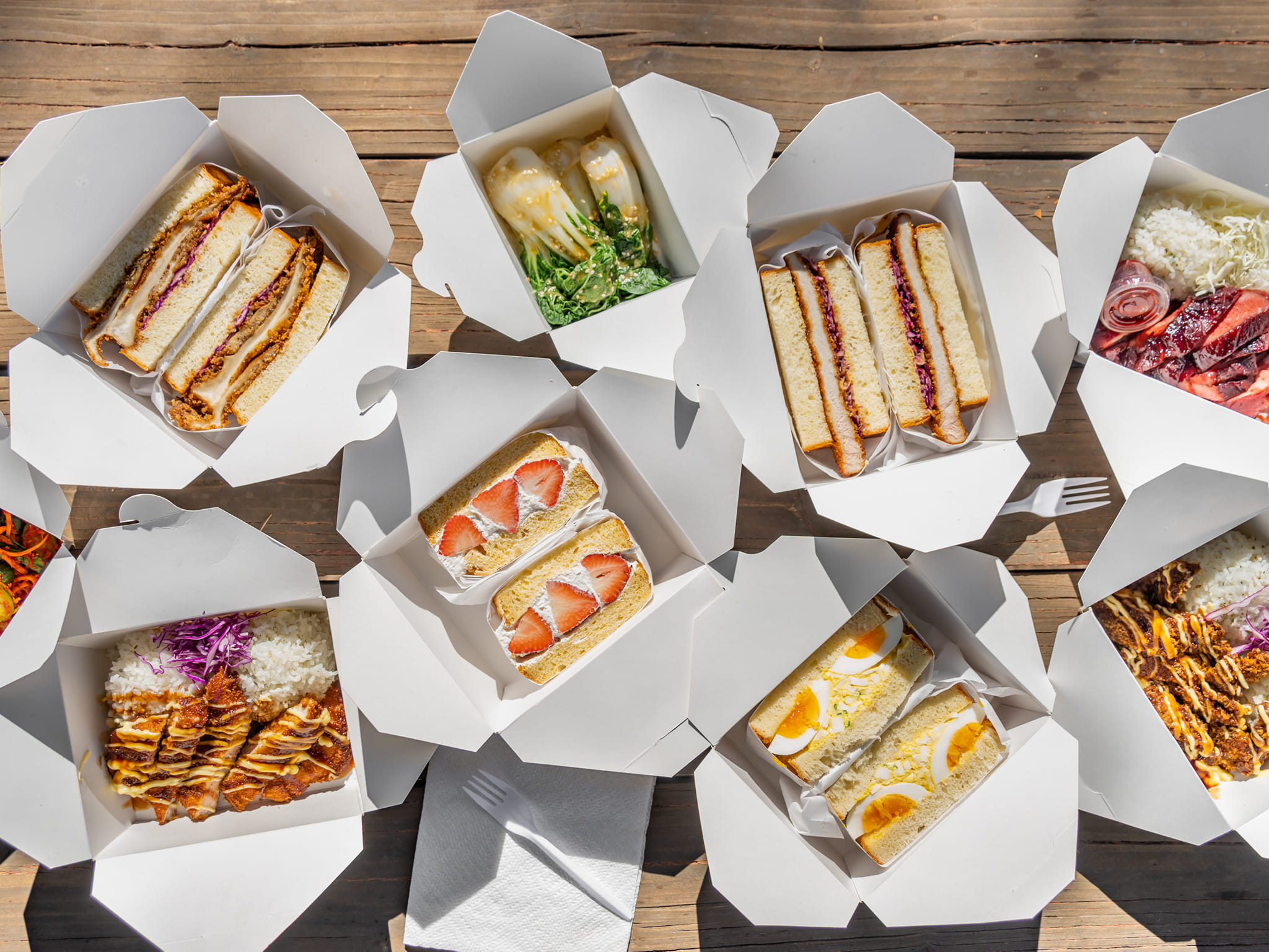 A picnic table is adorned with Japanese sandwiches from Tucson restaurant Fatboy Sandos.