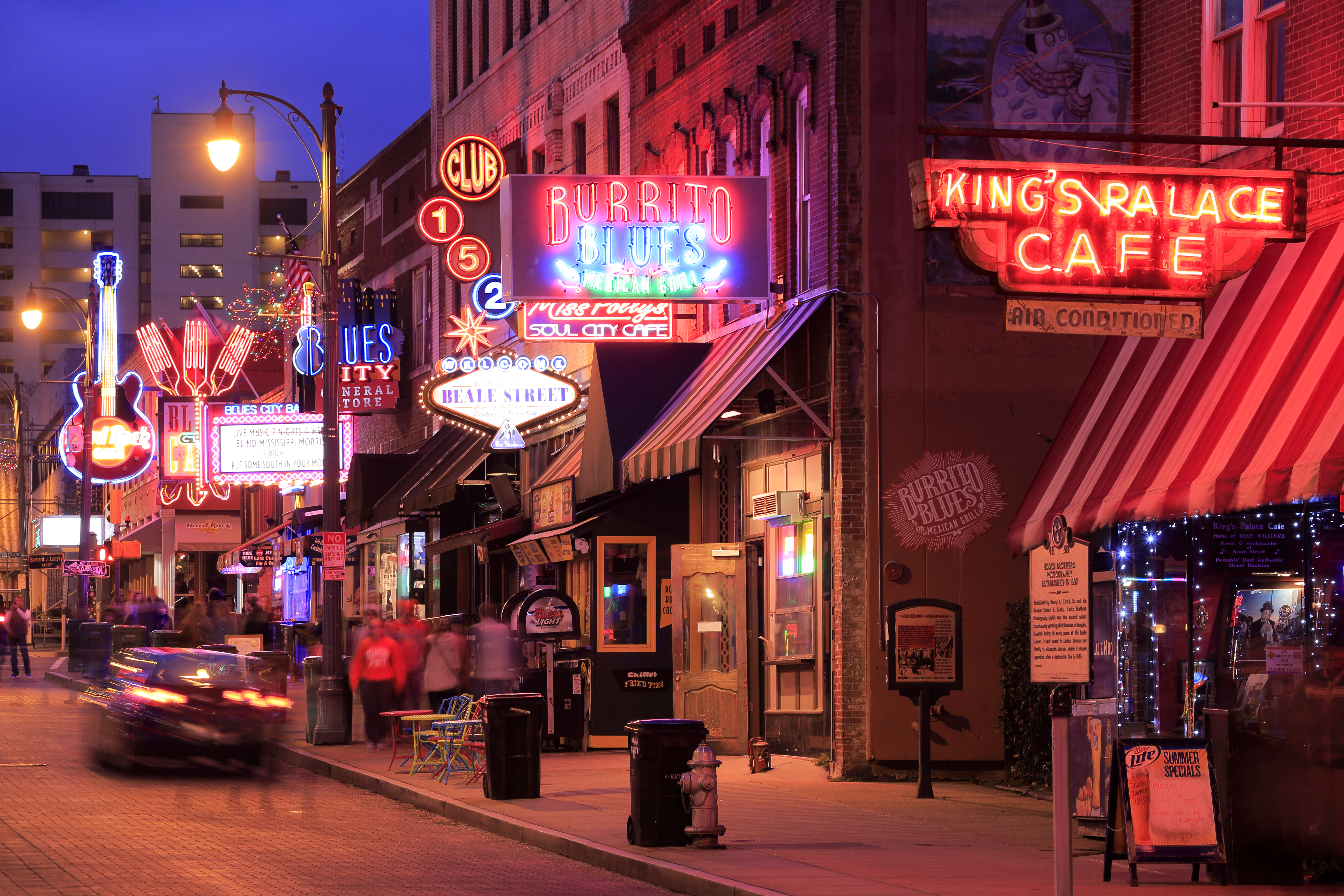 A nighttime shot of Memphis’s famous Beale Street, where neon lights buzz above various restaurants, bars, and blues venues. 