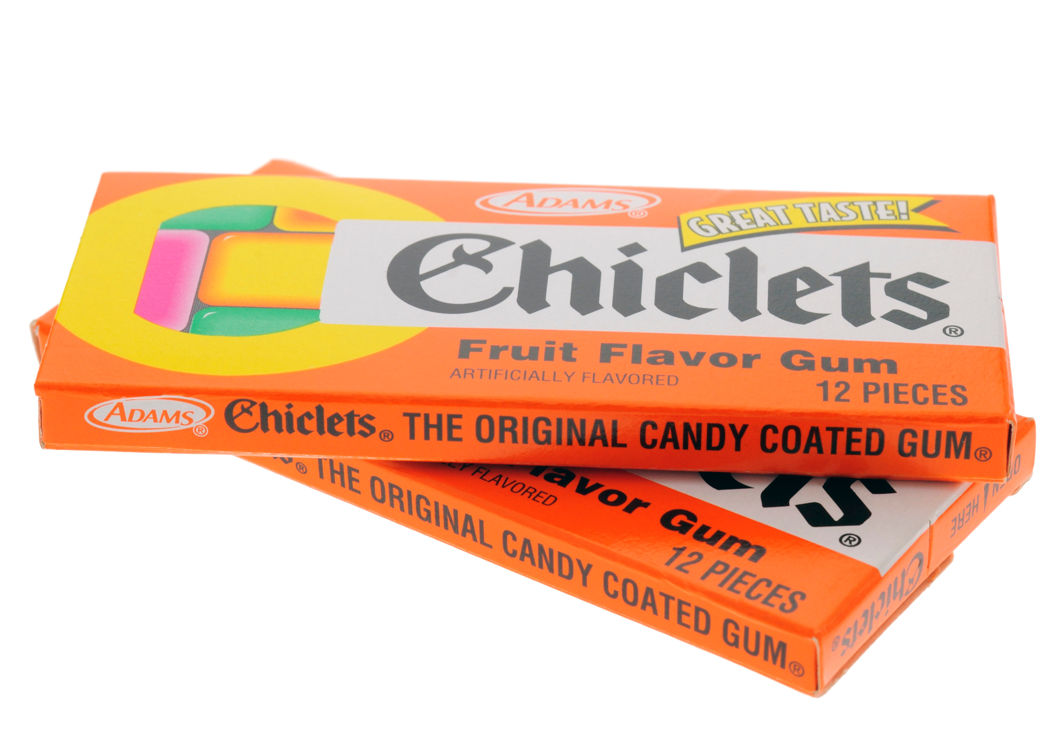 A stack of two bright orange retro packets of Chiclets gum, decorated with candy-color graphics.